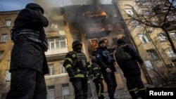 Firefighters work to put out a fire at a residential building hit by a Russian military strike in Bakhmut on December 7.