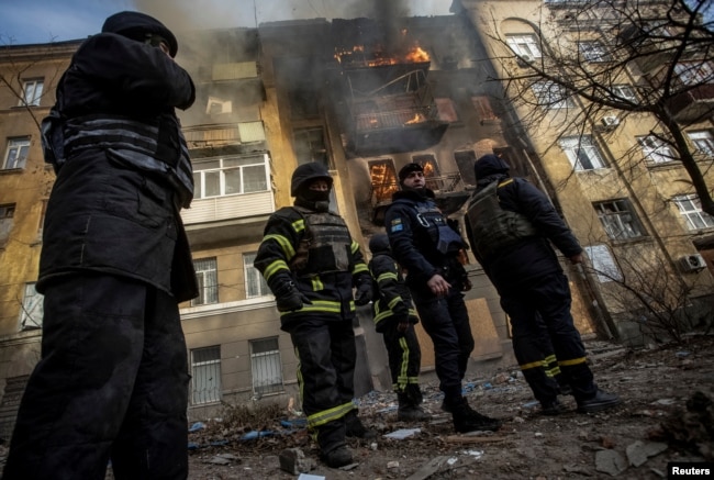 Firefighters work to put out a fire at a residential building hit by a Russian missile strike in Bakhmut on December 7.