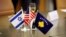 ISRAEL -- The flags of Israel, Kosovo and the U.S. are seen on a desk during a virtual ceremony to sign an agreement establishing diplomatic relations between Israel and Kosovo in the Israeli foreign ministry in Jerusalem, February 1, 2021