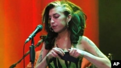 Amy Winehouse on stage during her disastrous last concert, in Belgrade, on June 18.