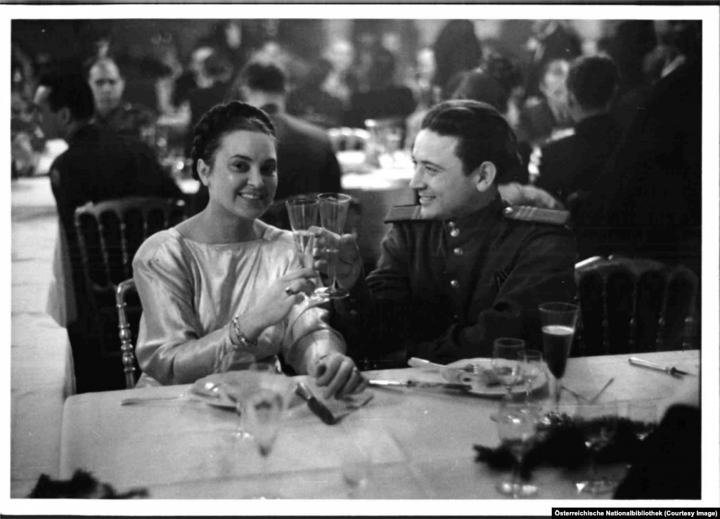 A Soviet soldier clinks flutes with a date during a party inside the Hofburg, the former imperial palace of the Habsburgs.