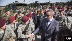 Estonian President Hendrik Ilves greeting U.S. troops in Estonia.