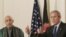Karzai (left) listens as Bush answers questions at the White House on September 26