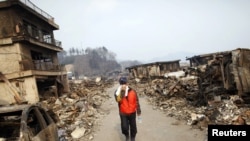 A man walks through a former residential area of his home village of Otsuchi.