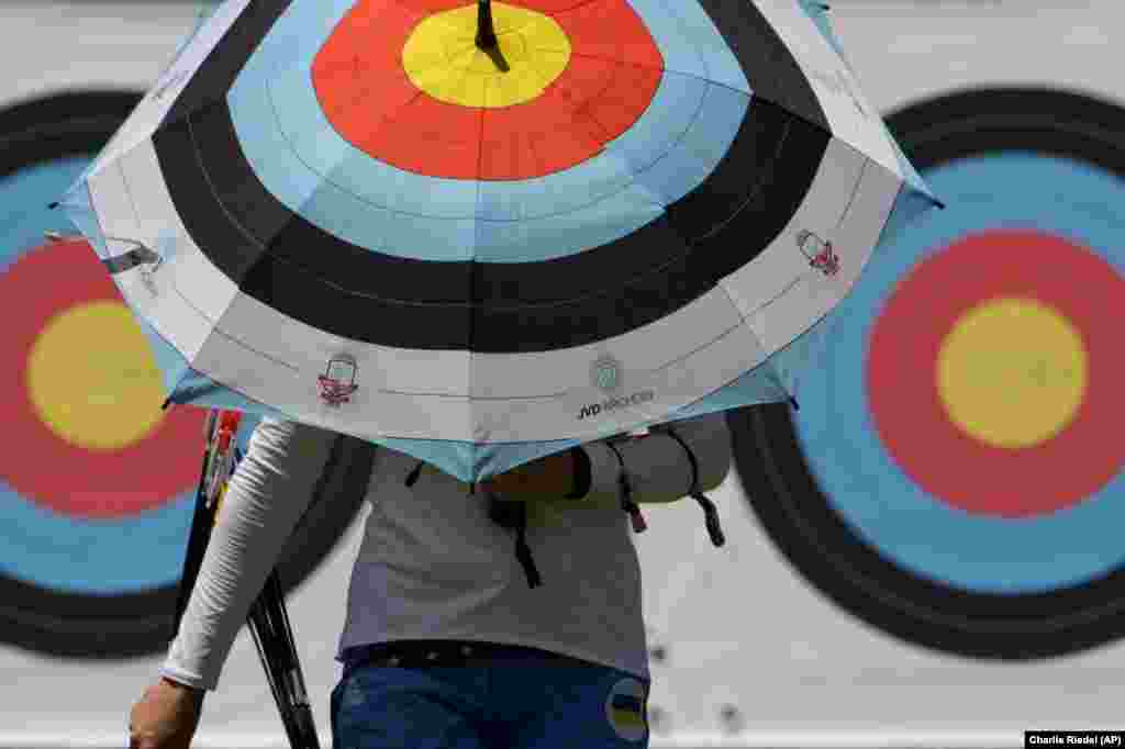 An athlete from Ukraine walks to the firing area as she practices for the 2020 Summer Olympics at Yumenoshima Park Archery Field in Tokyo.