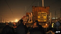 Police arrive as Greenpeace activists put a banner reading "Russia is not a trash can" in Valenton, France on March 11.