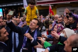 Мэр Стамбула и кандидат от Республиканской народной партии (НРП) Экрем Имамоглу фотографируется со своими сторонниками во время предвыборного митинга в Стамбуле, 21 марта 2024 года