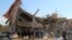 People gather near the ruins of a hospital supported by Doctors Without Borders (MSF) near Maaret al-Numan, in Syria's northern province of Idlib on February 15.