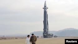 Лидерот на Севрна Кореја Ким Џонг Ун, заедно со неговата ќерка, се оддалечува од интерконтиненталната балистичка ракета (ICBM) на оваа фотографија без датум објавена на 19 ноември 2022 година од севернокорејската централна новинска агенција (KCNA).