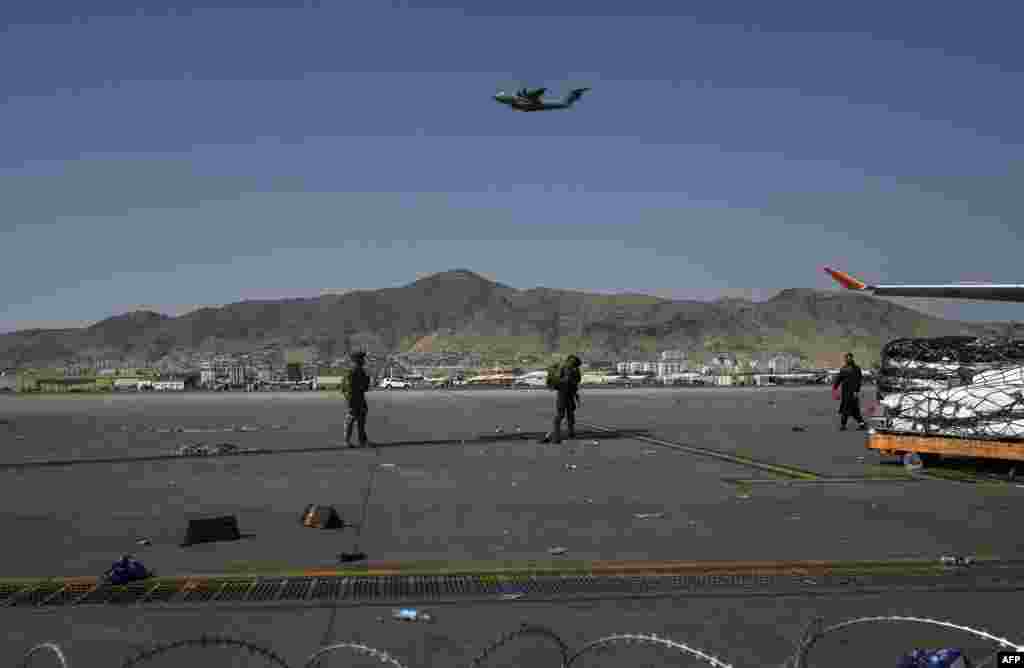 Солдати США стоять на варті в аеропорту Кабула, коли злітає літак, 16 серпня 2021 року