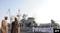 Clerics stand in front of the "Jamaran," Iran's first domestically built warship, during naval maneuvers in the Persian Gulf in February 2010.