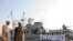 Clerics stand in front of the "Jamaran," Iran's first domestically built warship, during naval maneuvers in the Persian Gulf in February 2010.