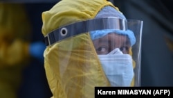 Armenia -- A medical worker wearing protective gear is seen outside the Grigor Lusavorich Medical Center in Yerevan on June 9, 2020.