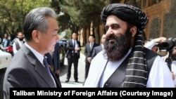 Chinese Foreign Minister Wang Yi (left) and the Taliban government's acting foreign minister, Amir Khan Muttaqi, in Kabul in August 2025

