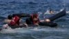 Refugees float as they hold a tube after a dinghy carrying Syrian and Afghan refugees deflated some 100m away before reaching the Greek island of Lesbos, September 2015.