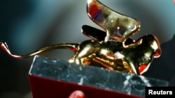 Italy, Swedish director Roy Andersson holds the Golden Lion prize for his movie "A Pigeon Sat on a Branch Reflecting on Existence" during the award ceremony at the 71st Venice Film Festival September 6, 2014. REUTERS/Tony Gentile