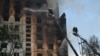 Rescue crews work to extinguish a fire in a residential building following a missile attack in Kharkiv on August 30.