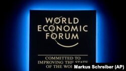 A Forum's logo shines during the annual meeting of the World Economic Forum in Davos, January 23, 2018