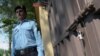 A Pakistani policeman stands guard outside the shuttered office of the international aid group Save the Children in Islamabad on June 15.