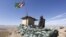 An Afghan National Army (ANA) soldier keeps watch at a check post in Logar province.
