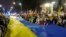 Participants carry a giant Ukrainian flag to mark the one-year anniversary of the Russian invasion of Ukraine in front of the Russian Embassy in Warsaw on February 24. 