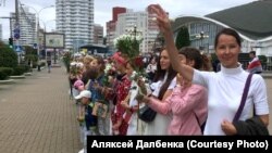 Maryya Dalbenka joins a chain of protesters in Minsk last year.