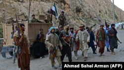 Afghan resistance forces patrol a road in Rah-e Tang, Panjshir Province, on August 29.