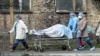 Ukrainian medical workers carry a body on a stretcher from a hospital to the morgue in Kyiv last week amid a wave of deaths and hospitalizations due to COVID-19. 