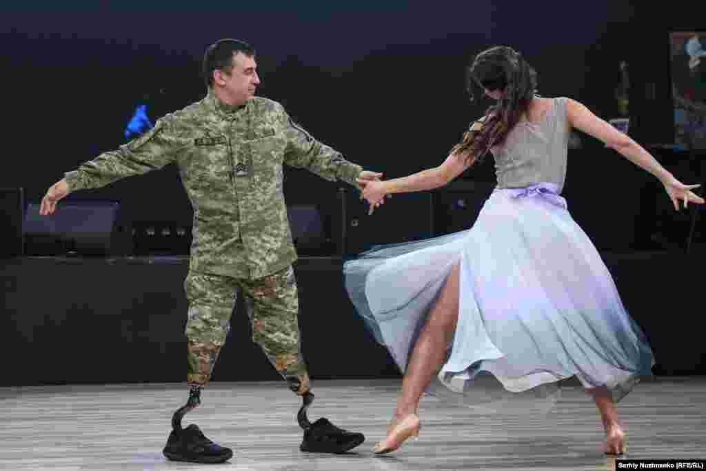 Ukrainian soldier Artem dances with partner Polina at the Brave Hearts charity ball in Kyiv on May 31. "On the one hand, it's very simple," the serviceman said, describing dancing as a double amputee, "on the other hand it's physically very difficult. You have to dream, set goals, move forward, and prove by example that nothing is impossible."Photo by Serhiy Nuzhnenko/RFE/RL's Ukrainian Service.
