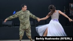 آرتم، سرباز اوکراینی، روز ۳۱ مه در مراسم خیریه «قلب‌های شجاع» در کی‌یف، همراه با شریک خود پولینا می‌رقصد. این نظامی، در توصیف رقصیدن به‌عنوان فردی با قطع هر دو پا گفت: «از یک طرف خیلی ساده است، اما از طرف دیگر از نظر جسمی بسیار دشوار است. باید رویا داشت، هدف تعیین کرد، به جلو حرکت کرد و با عمل نشان داد که هیچ‌چیز غیرممکن نیست.»<br>عکس: سرهی نوجننکو / بخش اوکراینی رادیو اروپای آزاد/رادیو آزادی