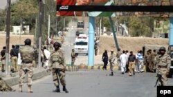 FILE: Paramilitary soldiers inspect the site of an attack in Balochistan.