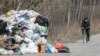 An elderly man wearing a respirator rides a bicycle past garbage bags to the grocery store during a lockdown, in Ramenskoye, outside Moscow, on April 9.