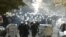 Riot police run down a street during clashes in Belgrade with antigay protesters on October 10.