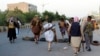 Private militiamen patrol the streets following fighting between Taliban and Afghan forces in Herat Province on August 6.