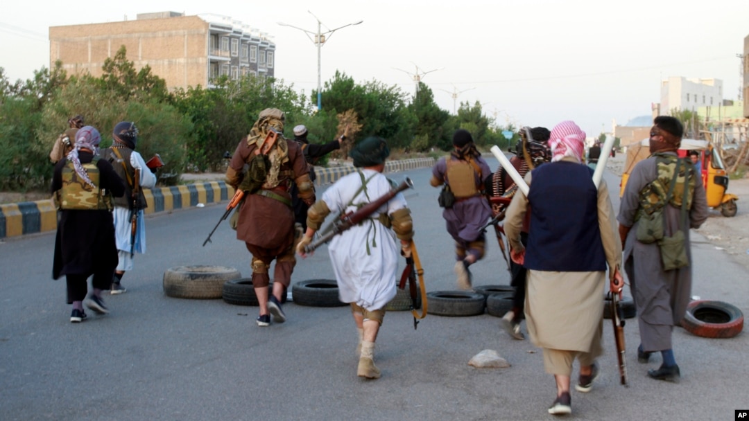 Private militiamen patrol the streets following fighting between Taliban and Afghan forces in Herat Province on August 6.