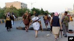 Private militiamen patrol the streets following fighting between Taliban and Afghan forces in Herat Province on August 6.