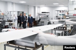 Russian President Vladimir Putin (center) visits a drone production facility in St. Petersburg. (file photo)