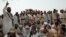 FILE: Residents of the town of Bara in the Khyber tribal district debate the fate of minority Sikhs threatened by a fanatical cleric in 2002.