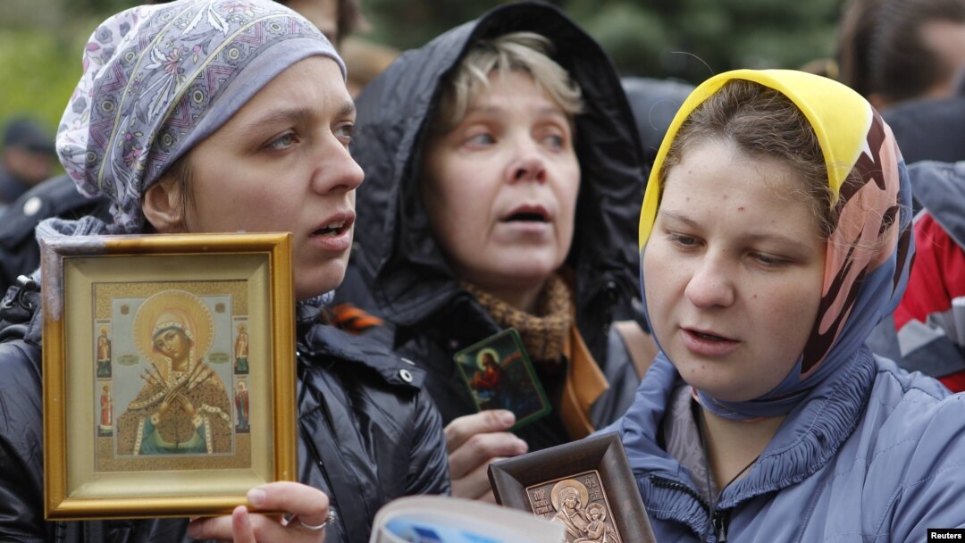 Russian Orthodox believers gather outside a court building during the trial of members of the female punk collective "Pussy Riot" for hooliganism motivated by religious hatred earlier this year. 