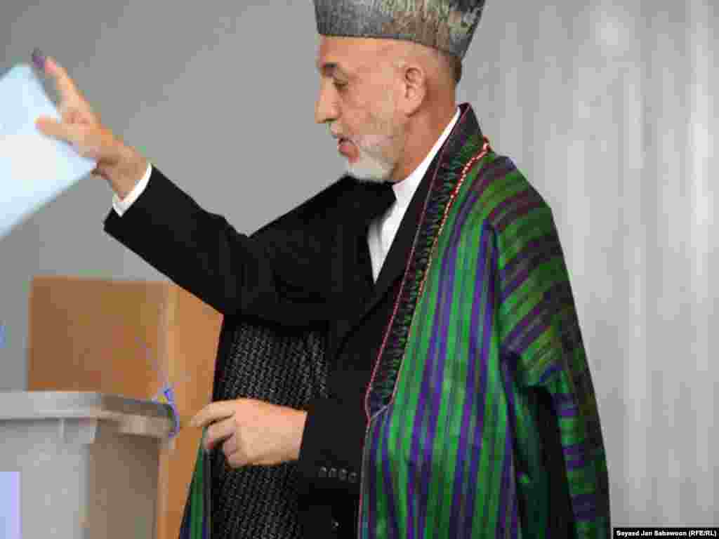 On election day, President Hamid Karzai casts his vote at a polling station in Kabul.