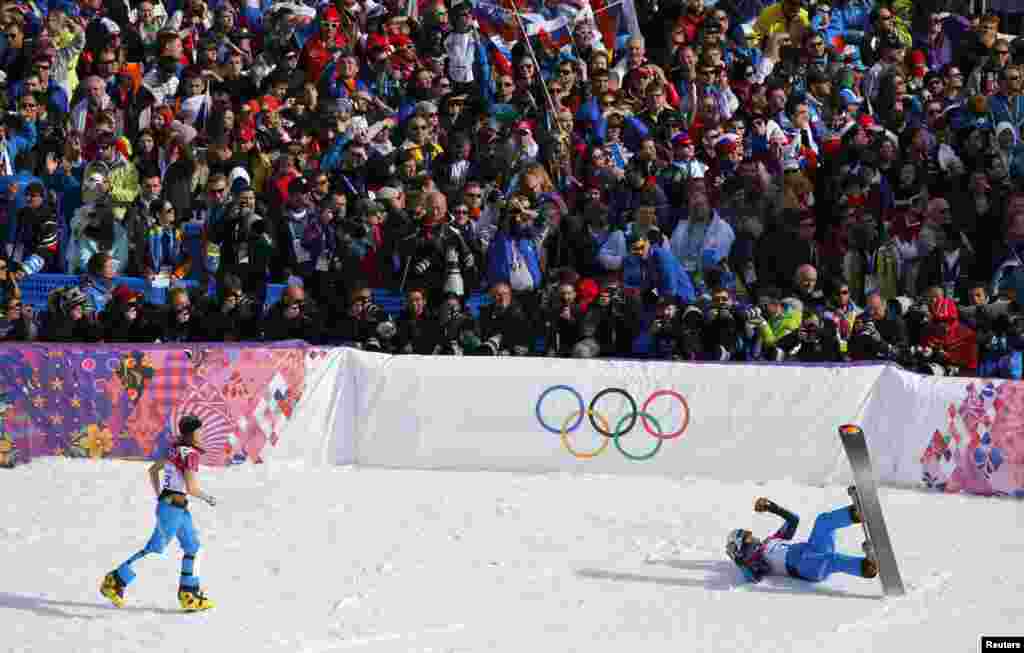 Austria&#39;s Julia Dujmovits (left), winner of the women&#39;s parallel slalom snowboard final, runs towards her compatriot Benjamin Karl, who finished third in the men&#39;s competition. (Reuters/Mike Blake)