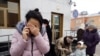 Aqmaral Akhmetova reacts outside the Kazakh Prosecutor-General's Office after the death of her mother Maira Rysmanova in Astana on December 14
