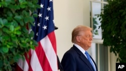 U.S. President Donald Trump waits to greet Armenia's Prime Minister Nikol Pashinian at the White House, August 8, 2025.
