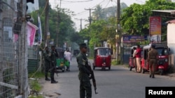 Sri Lankan military personnel stand guard near a hospital where Iranian sailors were being treated.
