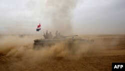 An Iraqi forces tank advances south of Mosul