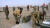 NATO troops along with Afghan National Army (ANA) soldiers prepare shells during a training session of ANA soldiers at Arena base in the Guzara district of Herat Province.