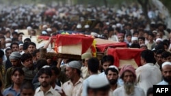 Relatives and residents carry the coffins of bomb victims during a funeral procession of victims of a Peshawar bombing in late September.