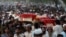 Relatives and residents carry the coffins of bomb victims during a funeral procession of victims of a Peshawar bombing in late September.