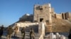 Syria - Opposition fighters take pictures with their cellphone next to the Old City in Aleppo, November 30, 2024. 