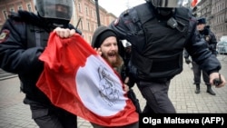 Russian riot police detain an opposition activist of the Other Russia political movement in St. Petersburg on November 6.